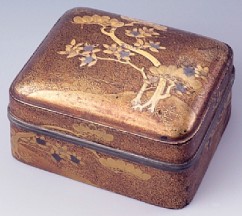 Incense Box (kogo) 

Pine and Tachibana Trees (citrus nobilis) 

Anonymous artist    

Lacquered wood, lead rim 

Design in gold takamaki-e on nashiji 

Early 17th c. 

9.1 x 7.5 x 5 cm