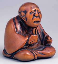 Katabori Netsuke, Old Man Pulling Hairs From his Beard 

Anonymous artist 

Boxwood 

First half of the 19th c. 

Height: 3.7 cm