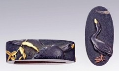 Fuchi and Kashira (Sword Hilt Accessories) 

Fuchi: Duck and Reeds 

Kashira: Duck and Crescent Moon 

Goto School 

Shakudo, gold, silver and copper inlay, nanako (dots) background 

18th c. 

Fuchi: 3.8 cm, Kashira: 3.4 cm