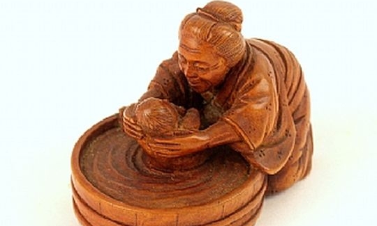 Grandmother bathing her grandchild in a tub