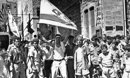 Oskar TauberAvraham Fiso waving an Israeli flag